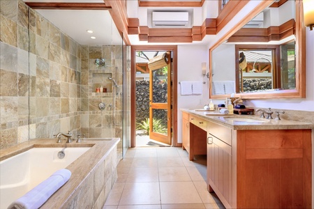 The ensuite bathroom feature a soaker tub and shower, providing a spa-like experience for all guests.