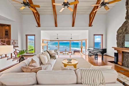 Wake up to panoramic ocean views in your bright living room where floor-to-ceiling windows frame endless blue waters and tropical coastline.