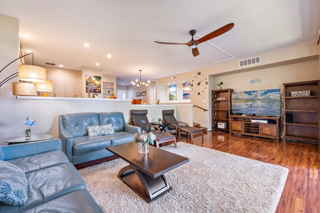 The living area features plush seating, large TV and central AC.