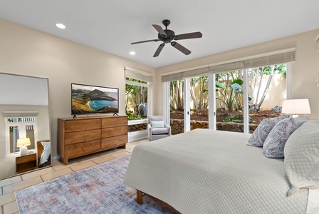 Your serene bedroom opens to a private tropical garden, where natural light filters through lush greenery while you relax in modern comfort.