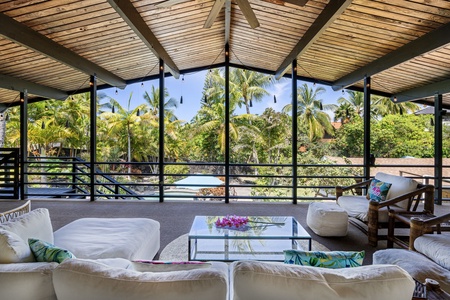 Your private tropical oasis awaits with plush seating and panoramic garden views where palm trees sway in the breeze.