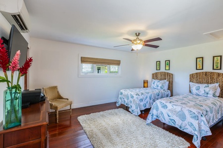 Located just off the primary suite, the open den features two twin beds - ideal for children or additional guests.