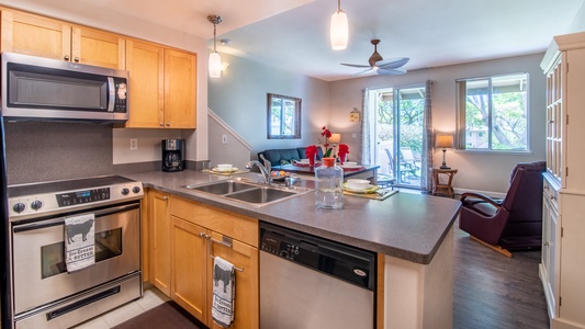 A beautiful kitchen with stainless steel appliances and a view.