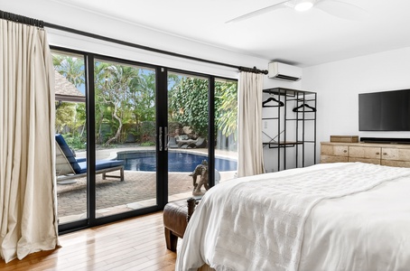 Wake up to your own private pool paradise through floor-to-ceiling glass doors that open your bedroom to tropical serenity.