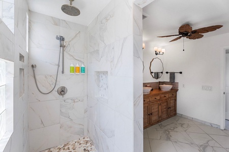 Step into the marble walk-in shower the primary suite was built around.