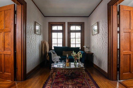 Upstairs hallway lounge with vintage rug and sitting area.