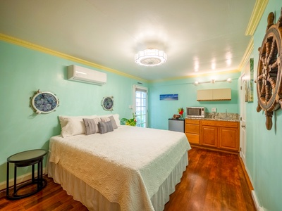 Drift off to sleep in this charming nautical-themed bedroom where seafoam walls and warm hardwood create your perfect coastal retreat.