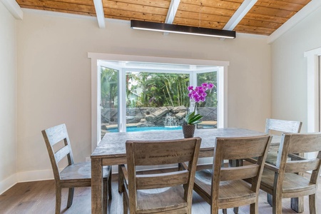 Share casual meals at Lani Oasis’ breakfast nook, framed by windows overlooking the pool and gardens.