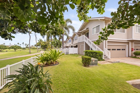 Tropical vacation home nestled among lush palm trees and manicured lawns with convenient parking and peaceful residential setting.