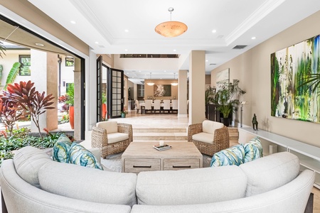 Relax in the main living room with garden views and soaring vaulted ceilings.