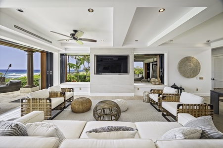 Relax in the comfort of white couches and big tv