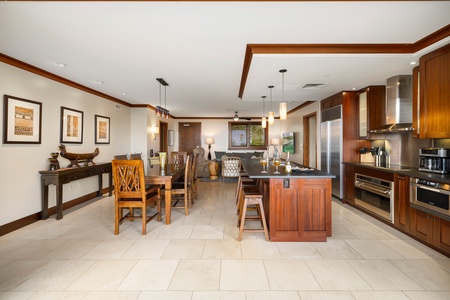 The kitchen and dining area features a large island, quality appliances, and a spacious table for meals.