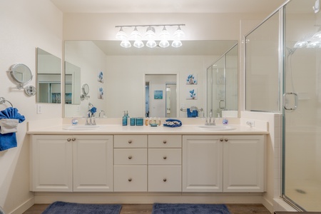 The spacious guest bathroom with a large vanity and ample lighting.