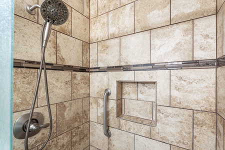 Step into a warm, inviting shower with elegant tilework and a glass enclosure – perfect for unwinding after a day of island adventures.