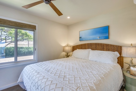 Rest peacefully in a bright and airy guest bedroom with tropical accents.