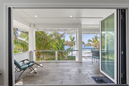 Oceanfront lanai with uninterrupted views and shaded seating—perfect for morning meditation.