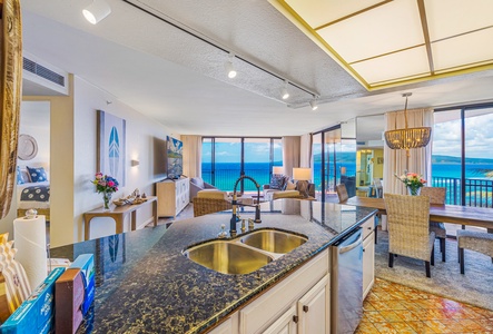 The open kitchen leads into a bright living area with stunning ocean views, making it an ideal space for cooking and entertaining.