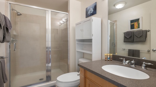 The ensuite bathroom features a walk-in shower, sleek vanity, and thoughtful touches designed for comfort and functionality.