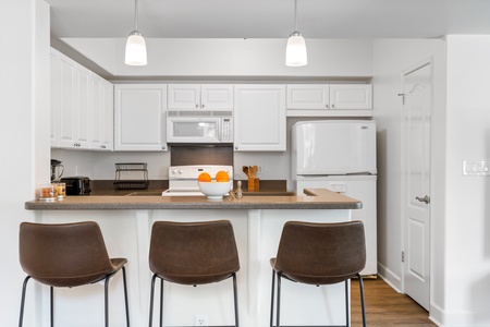 The breakfast bar for quick meals and entertainment has seating for three.