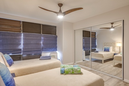 The bedroom also features a large mirror closet.