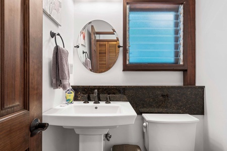 Charming powder room with a vanity steps from the laundry room