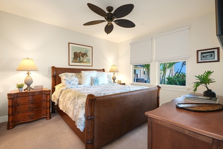 Cozy guest bedroom two offers a king bed and natural lighting.