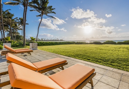 Bask in ocean glimpses and garden serenity from lounge chairs on the terrace.