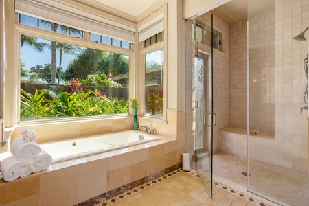 Indulge in a spa-like ensuite with a soaking tub, walk-in shower, and tranquil garden views.