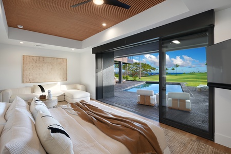 Relax in your luxurious primary suite with a plush king bed, where warm wood ceilings and soft textures invite peaceful mornings.