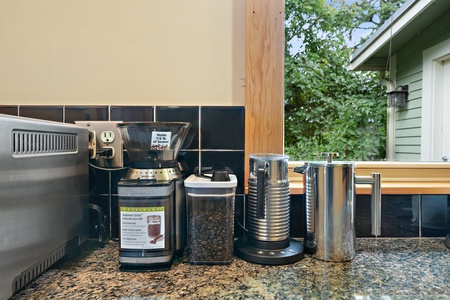 Enjoy your morning brew from this well-stocked coffee station, featuring a variety of options for guests.