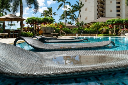Relax on the unique pool loungers, where you can unwind partially submerged in crystal-clear water surrounded by tropical paradise.