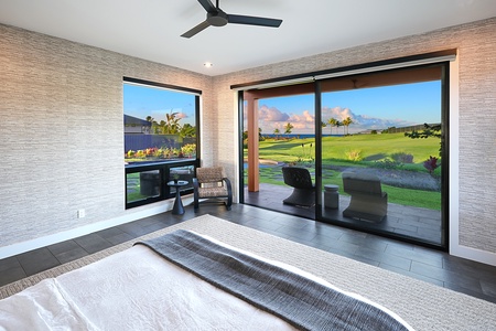 Guest suite with king bed, floor-to-ceiling windows, and serene golf course views, creating a peaceful private retreat.