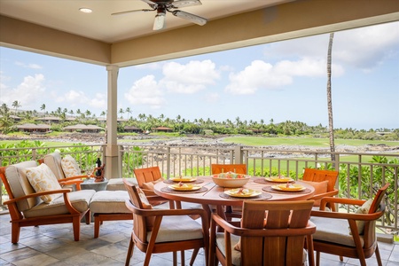 Dine al fresco with views of the golf course and swaying palms under the shaded lanai ceiling.