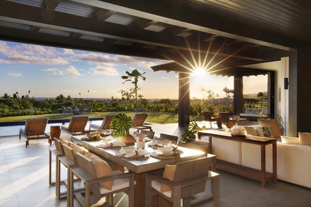 Outdoor living space with beautiful ocean and sunset views.