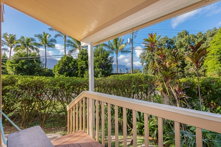 Covered lanai with views of lush foliage and mountain peaks—ideal for slow mornings and sunset unwinding.