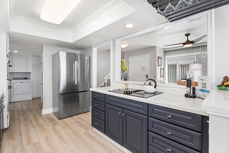 Kitchen view with stainless steel fridge and ample counter space for prepping meals.