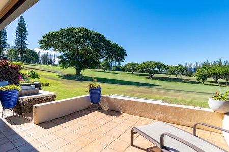 Relax in the inviting living space with a sliding door that opens to the lanai, offering stunning views for an exquisite indoor-outdoor living experience.