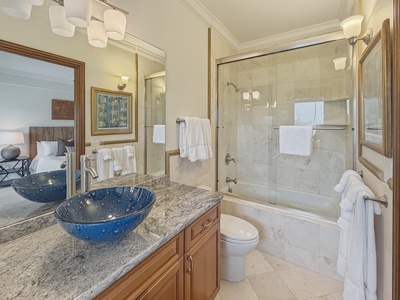 Elegant spa-inspired bathroom with marble details and plush towels awaiting your arrival.