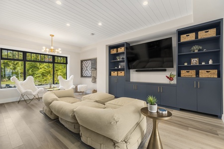 There is an additional family room with ample seating options, a piano & guitars, and a large smart television that is perfect for family movie nights.