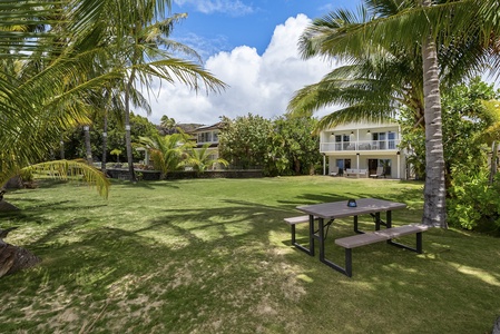 Shared green space with picnic table, ideal for outdoor gatherings.