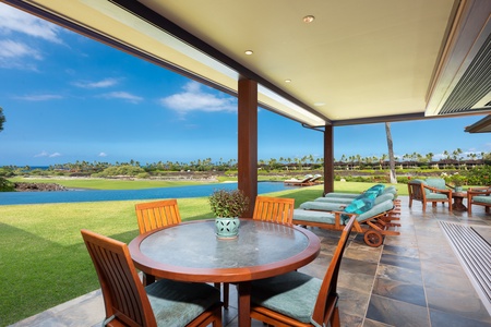 Covered lanai dining table ideal for breakfast with ocean views.