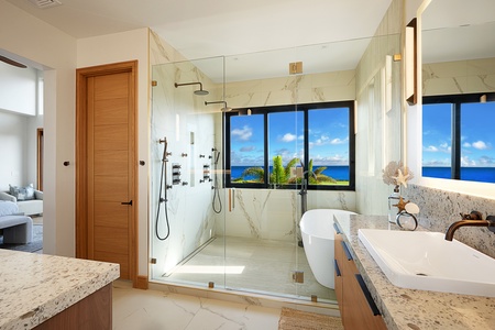 The spa-like ensuite bathroom with a large soaking tub and separate showers.