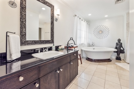 Another view of Primary Bedroom 2’s ensuite, featuring a spa-inspired tub and modern finishes.