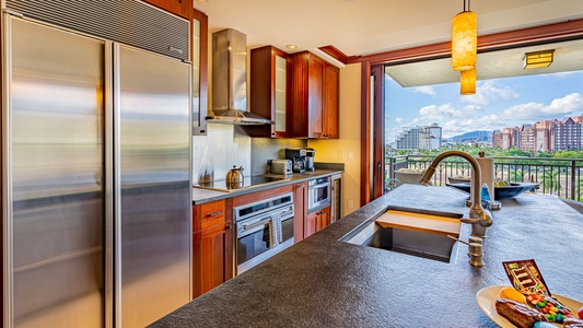 The kitchen has stainless steel appliances and island bar seating.