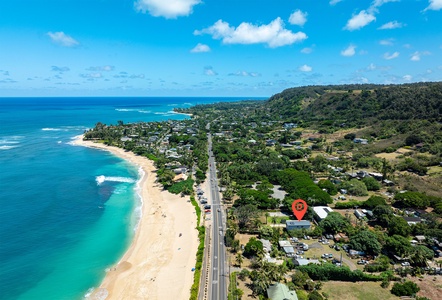 A breathtaking aerial view highlights the property’s easy beach access and the scenic coastal drives guests can explore.