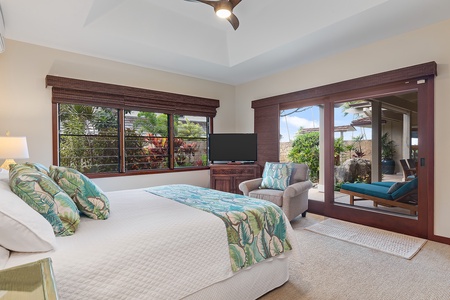Beach house spacious guest bedroom with a king-size bed, cozy seating, and garden vistas.