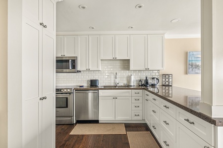 A modern, fully equipped kitchen with sleek finishes, perfect for coastal-inspired cooking.