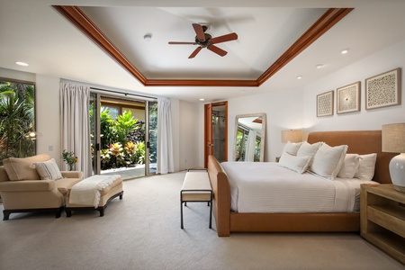 Reverse view of primary suite with valence ceiling and stunning natural light.