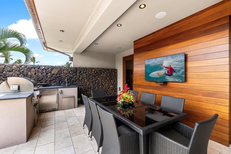 Covered lanai with dining table and seamless indoor-outdoor living.