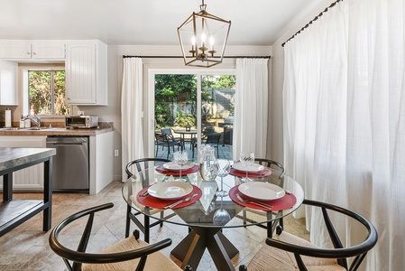 Elegant dining glass table for four with easy access to the patio.